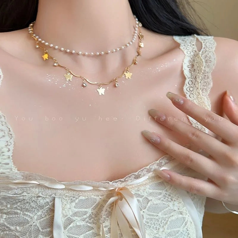 Collier papillon pompon cristal doré