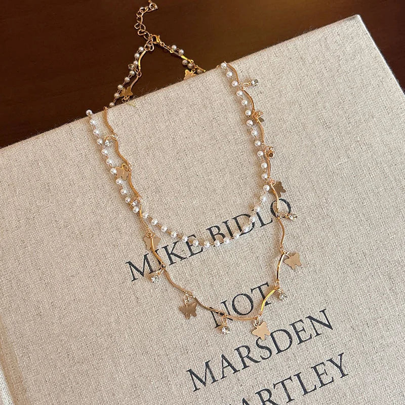Collier papillon pompon cristal doré
