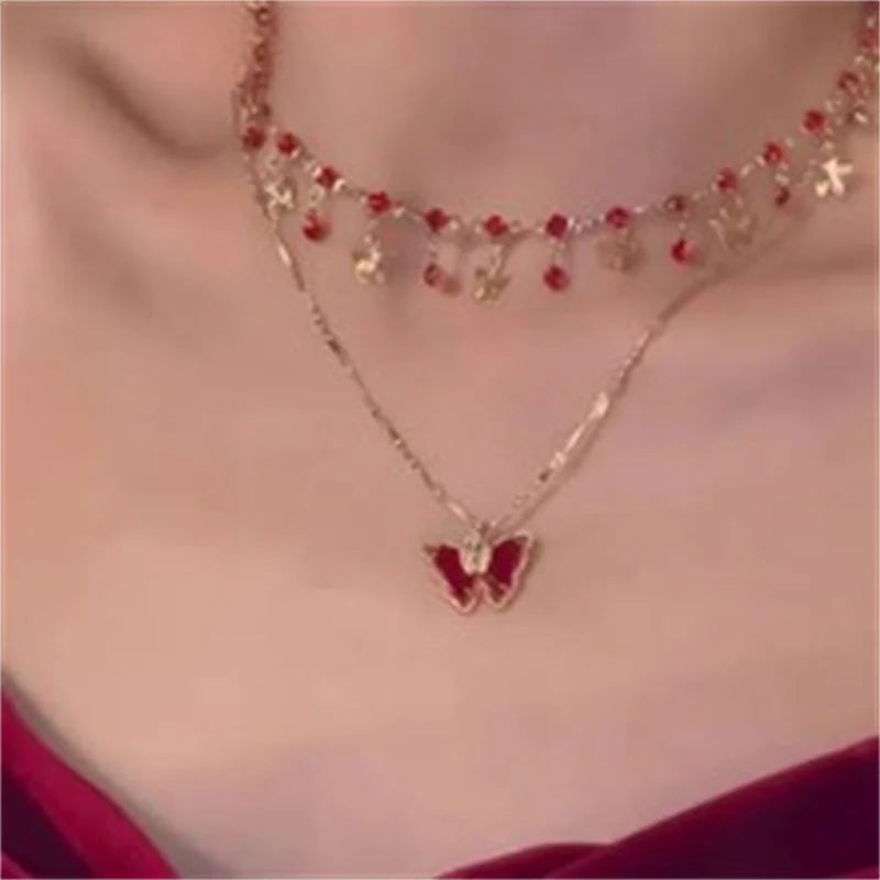 Collier papillon pompon cristal doré