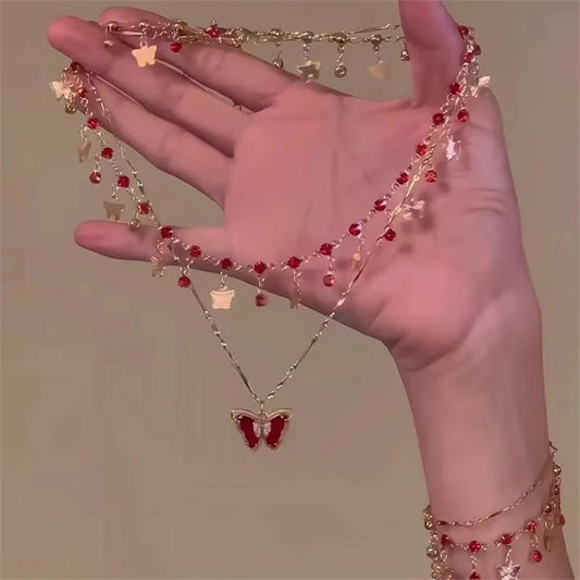Collier papillon pompon cristal doré