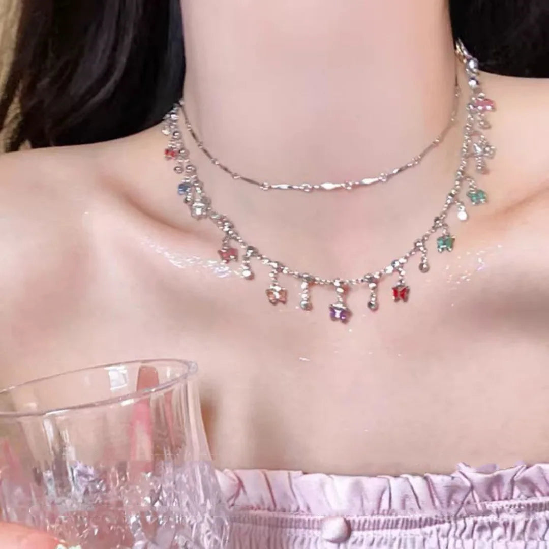 Collier papillon pompon cristal doré